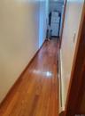 Hall featuring dark wood-type flooring and baseboards