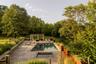 Swimming pool with a pergola, a patio area, and an in-ground hot tub