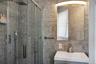 Bathroom with vanity, tile walls, and a shower stall