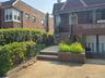 Doorway to property with brick siding and covered porch