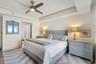 Tray ceilings add architectural detail and warmth to this spacious guest suite.