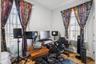 1st Floor Apartment bedroom features two windows providing natural light, white walls, and wood flooring