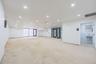 Spare room featuring unfinished concrete flooring, electric panel, and recessed lighting