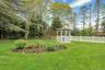 View of yard featuring a gazebo and view of wooded area