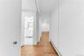 Hallway in lower level with bathroom and living area view