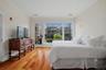 Spacious primary suite with a large private balcony showcasing beautiful views. (Bedding was virtually staged)