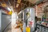 Utility room featuring gas water heater and heating unit