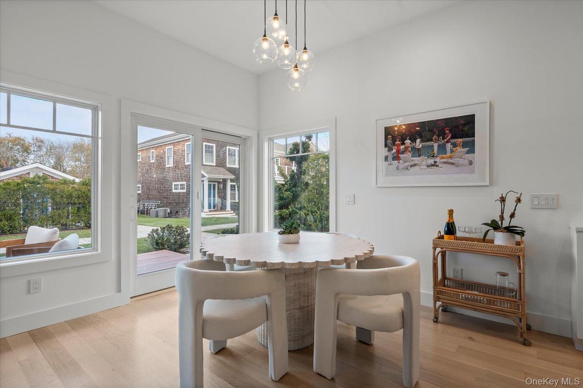 Dining room with light wood-type flooring and a chandelier
