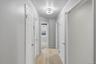 Hall with light wood-type flooring and baseboards