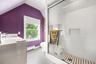 Bright and modern bathroom featuring a spacious glass-enclosed walk-in shower, contemporary tile finishes, and a large window that fills the space wit