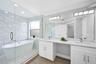 Updated bath with linen closet, dual sinks, bath, shower and separate water closet