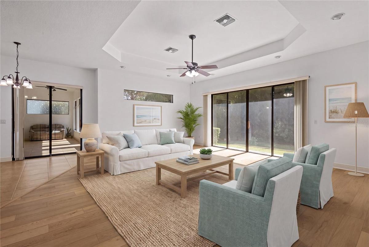 The family room is highlighted by an impressive 9-by-12-foot window framing protected conservation views. - virtually staged