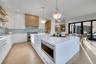 Kitchen featuring open shelves, appliances with stainless steel finishes, a large island, light wood-style floors, and white cabinets