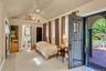 Guest cottage with lofted ceiling, access to exterior, light tile patterned floors, and ensuite full bathroom