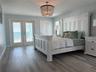 Primary bedroom with Gulf views and direct access to the covered porch.