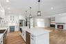 Kitchen featuring beverage cooler, appliances with stainless steel finishes, a sink, light wood-style floors, and recessed lighting