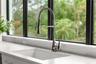 The large sink bowl sink and high-end faucet around surrounded by lots of counter top space.