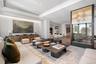 Living room with a tray ceiling, wood finished floors, and recessed lighting