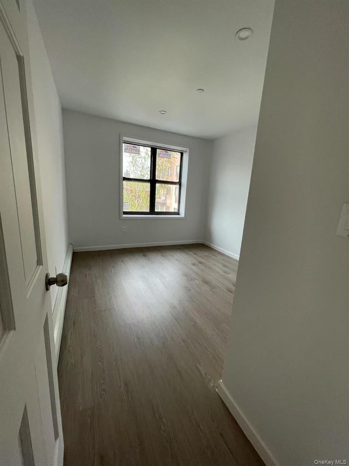 Empty room with wood finished floors and baseboards