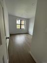 Empty room with wood finished floors and baseboards