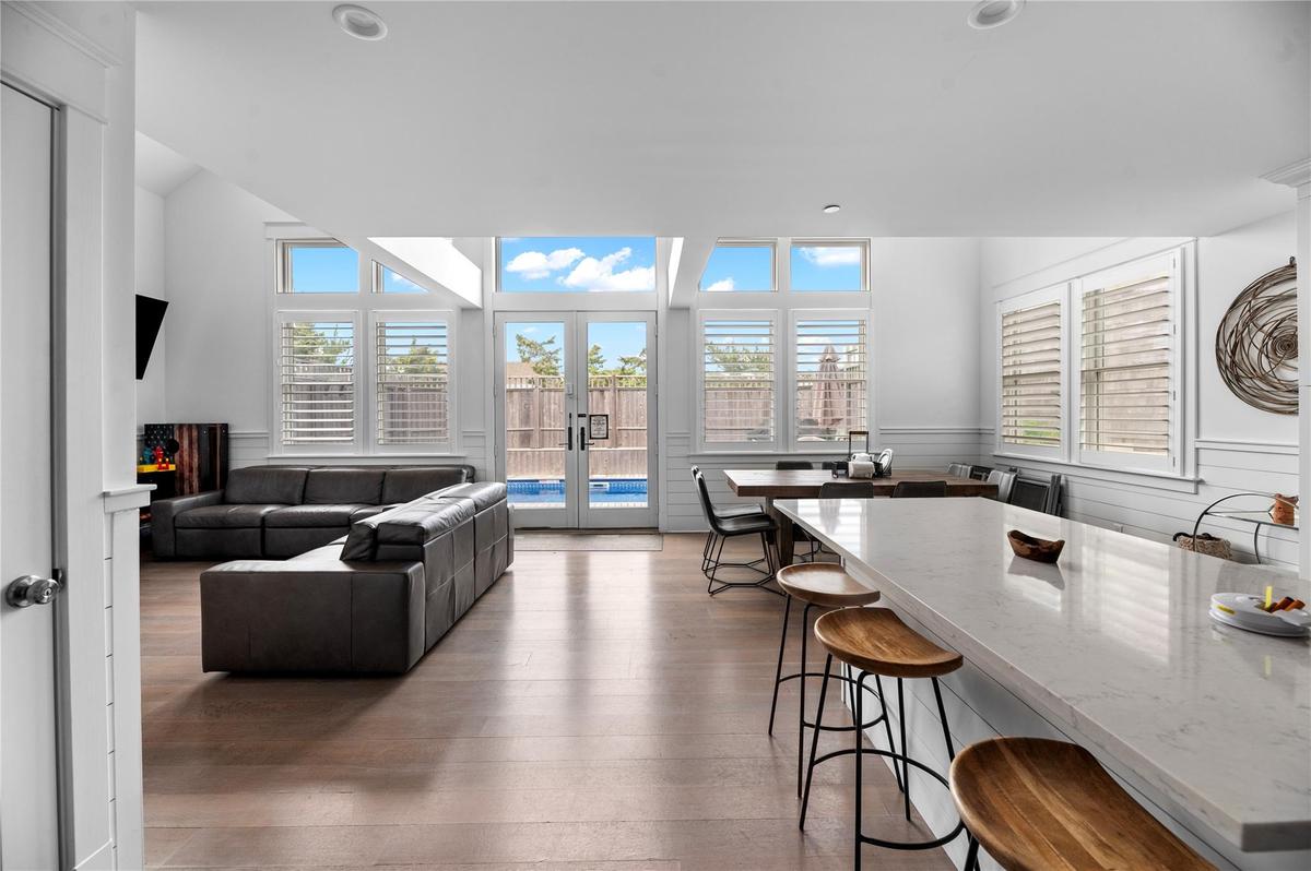 Living room with french doors, wood-type flooring, and plenty of natural light