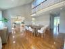 Dining room with wood finished floors, recessed lighting, a decorative wall, high vaulted ceiling, and ceiling fan