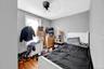 Bedroom featuring radiator, wood finished floors, and ceiling fan