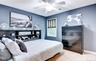 Carpeted bedroom featuring a ceiling fan with integrated lighting, and a window with blinds