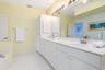 Dual vanity and linen cabinet provide ample storage.