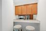 Breakfast bar with seating area open to kitchen