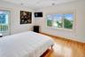 Third Oceanfront Bedroom with light wood-style floors, access to exterior, a ceiling fan, and recessed lighting