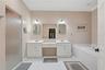 DUAL SINKS A WALK IN SHOWER AND A SOAKING TUB.