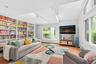 Living room with track lighting, healthy amount of natural light, and wood finished floors