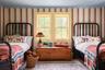 Bedroom with multiple windows and carpet flooring