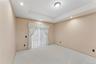 Master bedroom featuring a tray ceiling with recessed lighting and a central flush-mount fixture, neutral carpet flooring, and a window with sheer and