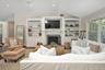 Living area with plenty of natural light, vaulted ceiling, a brick fireplace, wood finished floors, and recessed lighting