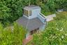 View from above of property with a tree filled landscape