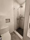 Master Ensuite Separate Shower Stall with luxurious ceramic tiles. Toilet with bidet.