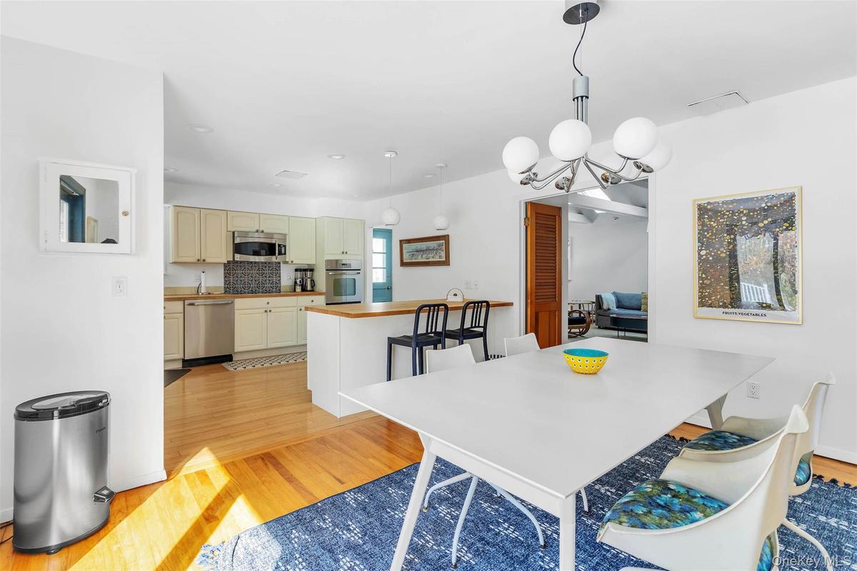 Dining space with a chandelier and light hardwood / wood-style flooring