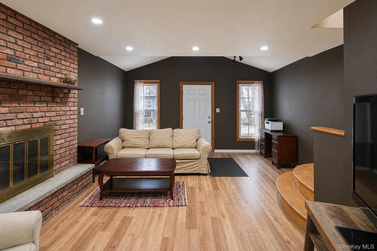 Brick fireplace with stone hearth and wood mantel