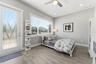 Generous 3rd Bedroom Upstairs with natural light and spacious balcony adding bonus outdoor living