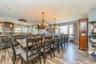Dining space featuring light wood-type flooring, a notable chandelier, and plenty of natural light