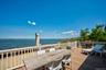 Expansive waterfront deck featuring composite decking and white railing system