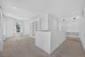 A spacious upstairs bonus area offers built-in shelving and room for a reading nook, office, craft space, or sitting area.