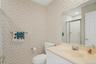Guest bathroom with shower in the hall adjacent to the second bedroom