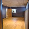 Unfurnished room featuring a paneled ceiling, wood finished floors, baseboards, and visible vents