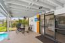 overed patio area adjacent to the pool, ideal for outdoor entertaining.