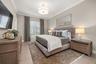 The other guest room has a walk-in closet, crown molding custom lighting, drapery and en-suite bathroom.