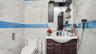 Half bath with vanity and tile walls