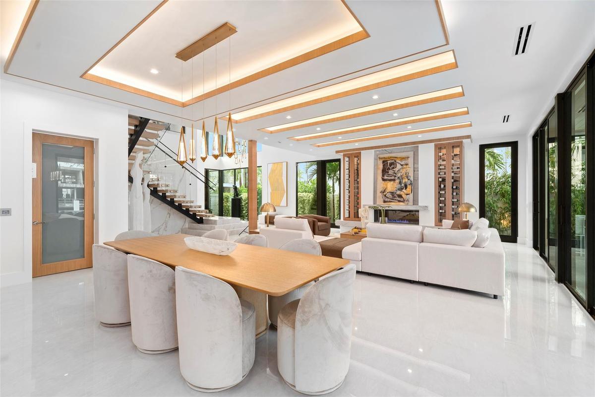 Surrounded by expansive windows, this elegant space is filled with natural light and showcases panoramic waterway views and lush tropical landscaping.